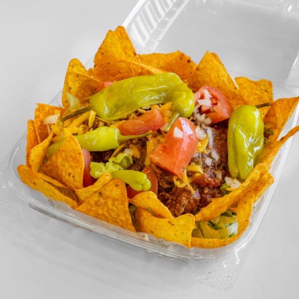 Unbeatable Eatables' taco salad with ground beef, cheese, tomatoes, peppers, and tortilla chips.